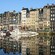 Multi-story buildings along a canal lined with sail boats